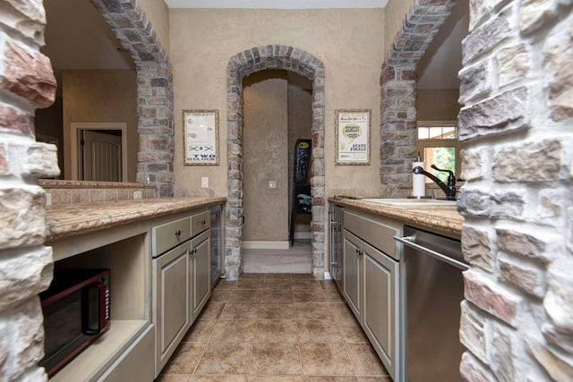 5853 S Northern Ridge Rd, Springfield, MO 65810 - kitchen featuring dishwasher, a sink, wine cooler, arched walkways, and baseboards