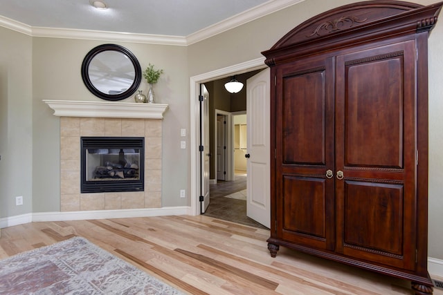 5853 S Northern Ridge Rd, Springfield, MO 65810 - living area with light wood-style floors, crown molding, a tile fireplace, and baseboards