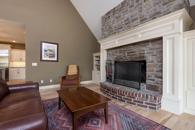 5853 S Northern Ridge Rd, Springfield, MO 65810 - living room with wood finished floors, baseboards, a fireplace, and high vaulted ceiling