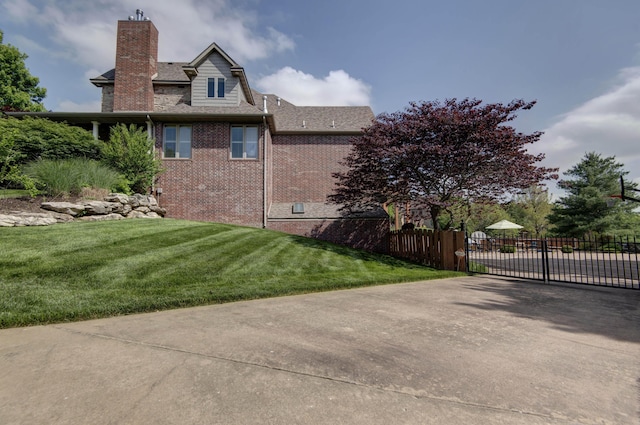 5853 S Northern Ridge Rd, Springfield, MO 65810 - view of side of property with a chimney, a gate, brick siding, and a shingled roof