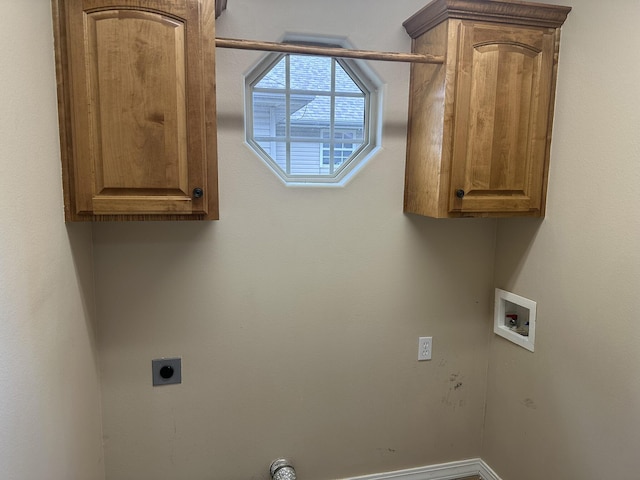laundry area with hookup for a washing machine, electric dryer hookup, cabinet space, and baseboards