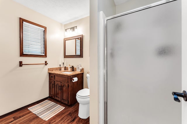 340 Greene Rd, Sparta, MO 65753 - bathroom with wood finished floors, a stall shower, toilet, vanity, and baseboards