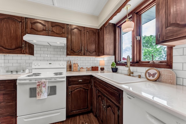 340 Greene Rd, Sparta, MO 65753 - kitchen with white appliances, under cabinet range hood, a sink, light countertops, and decorative backsplash
