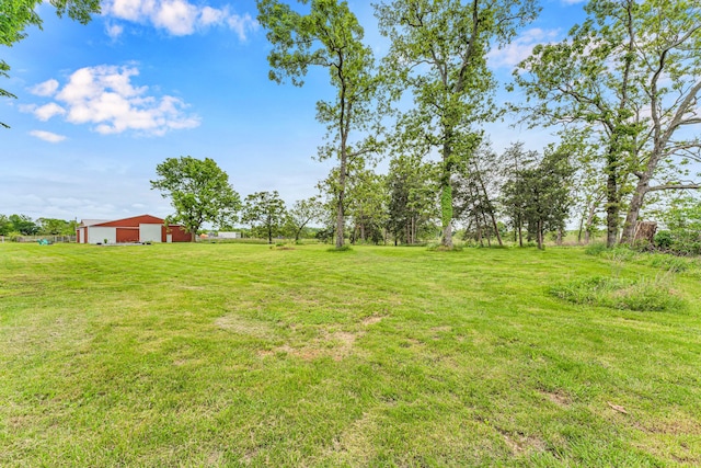 340 Greene Rd, Sparta, MO 65753 - view of green lawn featuring a pole building, a detached garage, and an outdoor structure