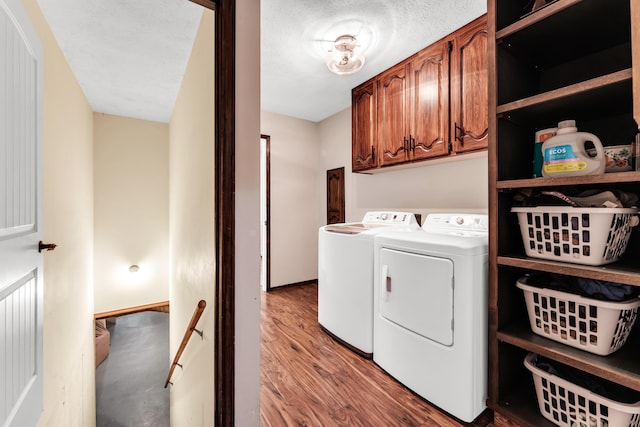 340 Greene Rd, Sparta, MO 65753 - laundry area featuring cabinet space, independent washer and dryer, and wood finished floors
