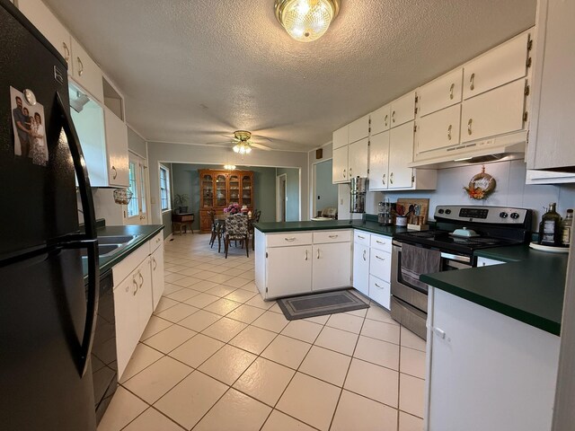 3036 P Hwy, Alton, MO 65606 - kitchen featuring stainless steel range with electric stovetop, freestanding refrigerator, under cabinet range hood, a peninsula, and dark countertops