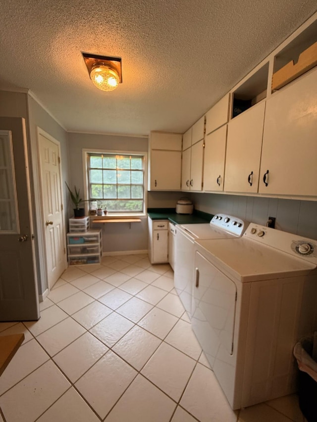 3036 P Hwy, Alton, MO 65606 - clothes washing area featuring cabinet space, independent washer and dryer, a textured ceiling, light tile patterned floors, and baseboards