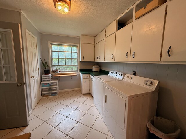 3036 P Hwy, Alton, MO 65606 - washroom featuring cabinet space, independent washer and dryer, a textured ceiling, light tile patterned floors, and ornamental molding