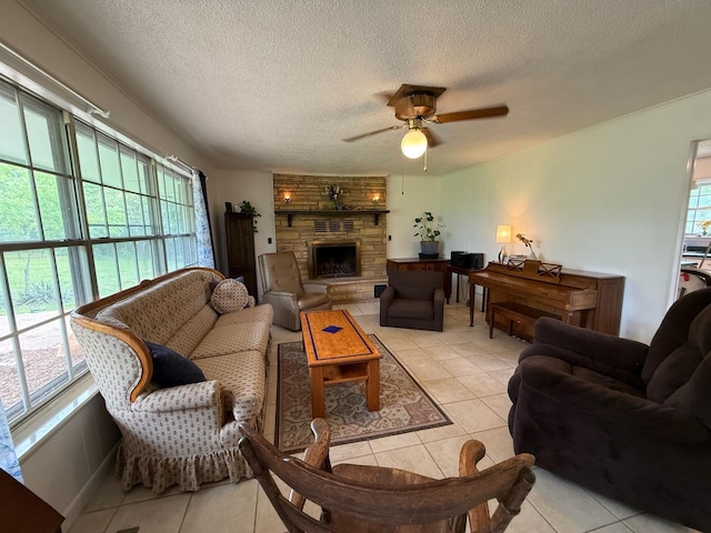 3036 P Hwy, Alton, MO 65606 - living area with light tile patterned floors, a ceiling fan, a textured ceiling, and a stone fireplace
