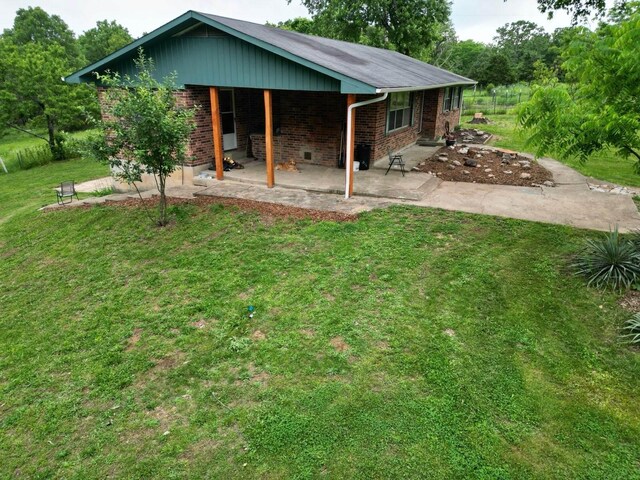 3036 P Hwy, Alton, MO 65606 - back of property featuring brick siding, a patio area, and a lawn