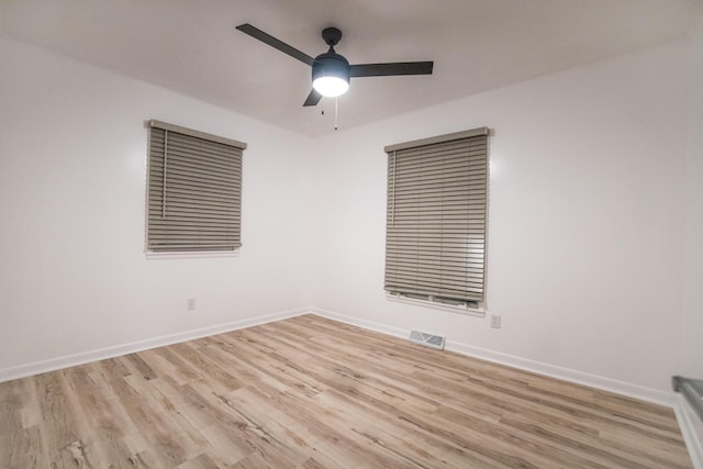 unfurnished room featuring ceiling fan, light wood-type flooring, and baseboards