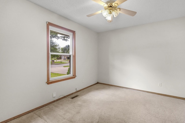 3563 S Western Ave, Springfield, MO 65807 - empty room with light colored carpet, baseboards, a ceiling fan, and a textured ceiling