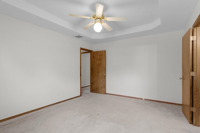 3563 S Western Ave, Springfield, MO 65807 - spare room featuring a raised ceiling, light colored carpet, and baseboards