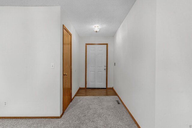 3563 S Western Ave, Springfield, MO 65807 - hallway featuring light carpet, a textured ceiling, and baseboards