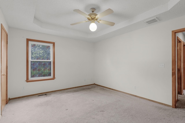 3563 S Western Ave, Springfield, MO 65807 - unfurnished bedroom featuring light carpet, a raised ceiling, baseboards, ceiling fan, and a textured ceiling