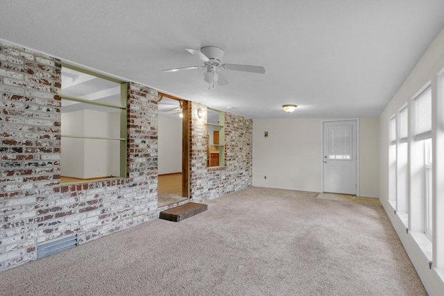 3563 S Western Ave, Springfield, MO 65807 - unfurnished living room with ceiling fan, carpet, and brick wall