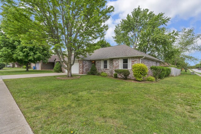 3563 S Western Ave, Springfield, MO 65807 - view of front of home featuring concrete driveway, a garage, a front lawn, and brick siding