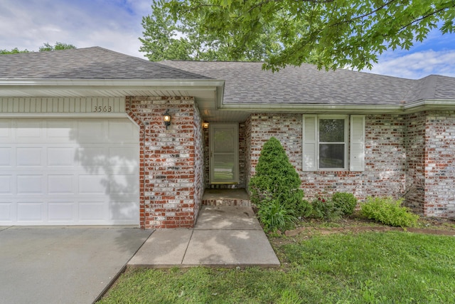 3563 S Western Ave, Springfield, MO 65807 - view of front of home featuring roof with shingles, brick siding, and an attached garage