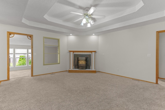 3563 S Western Ave, Springfield, MO 65807 - unfurnished living room with a tray ceiling, light carpet, and baseboards