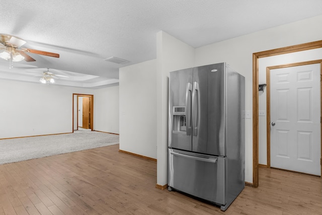 3563 S Western Ave, Springfield, MO 65807 - kitchen with stainless steel fridge with ice dispenser, a ceiling fan, baseboards, light wood-type flooring, and a textured ceiling