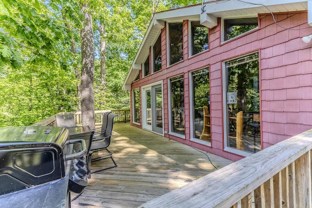 wooden deck featuring a grill