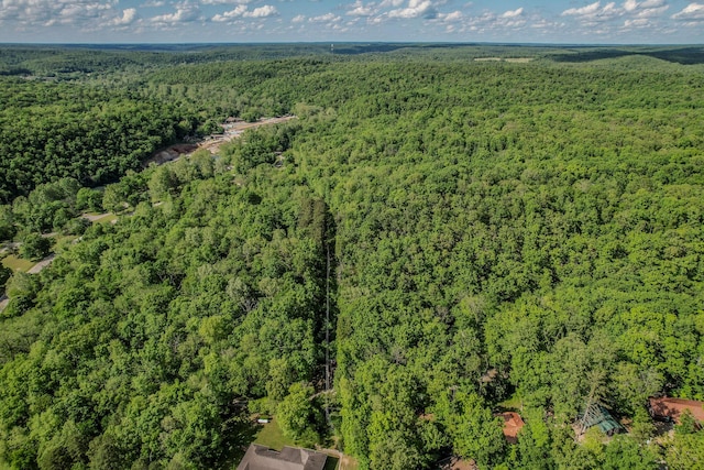 aerial view of property and surrounding area with a heavily wooded area