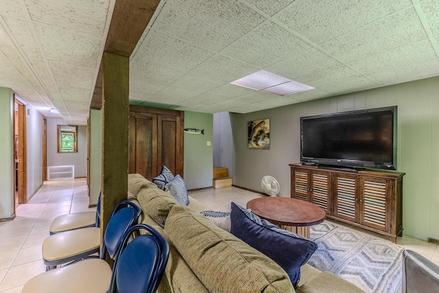 living area with light tile patterned flooring and a drop ceiling