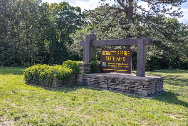 community / neighborhood sign with a lawn