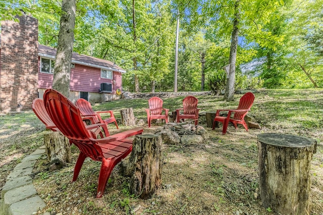 view of yard with a fire pit and cooling unit