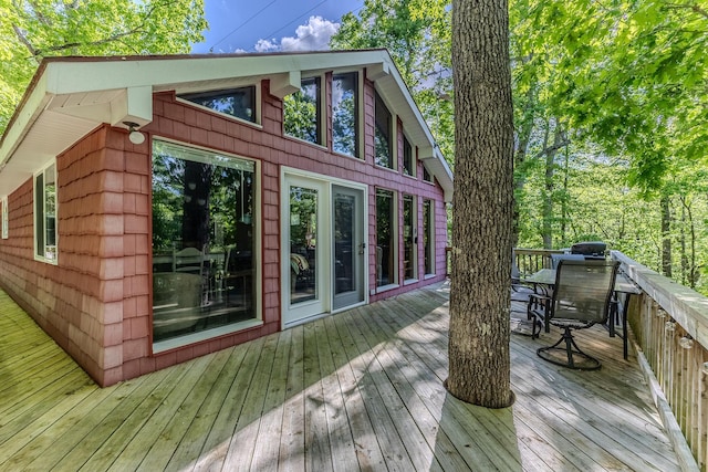 wooden terrace with outdoor dining area