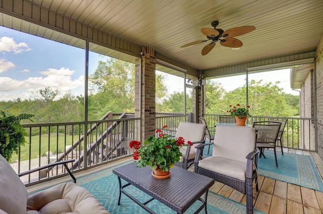 sunroom / solarium featuring ceiling fan and healthy amount of natural light