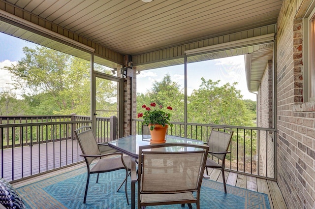sunroom with outdoor dining area