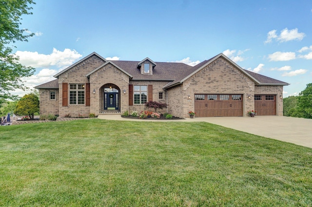 view of front of home featuring brick siding, a garage, driveway, a front yard, and roof with shingles