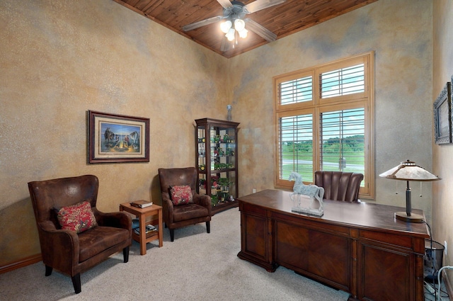 office featuring wood ceiling, plenty of natural light, a ceiling fan, light carpet, and a textured wall