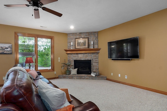 living area with ceiling fan, baseboards, carpet flooring, and a fireplace