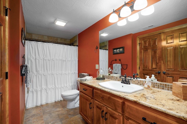 bathroom with toilet, vanity, and curtained shower