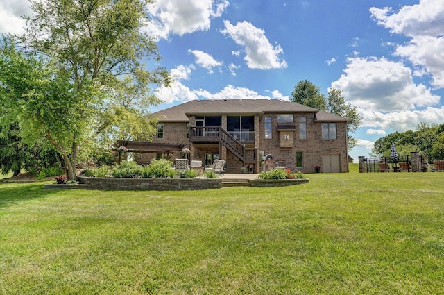 back of house with brick siding, stairway, a lawn, and a sunroom