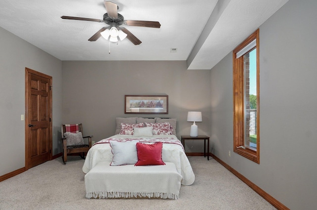 carpeted bedroom featuring baseboards and ceiling fan