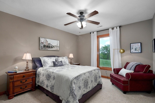bedroom featuring light carpet, baseboards, and ceiling fan