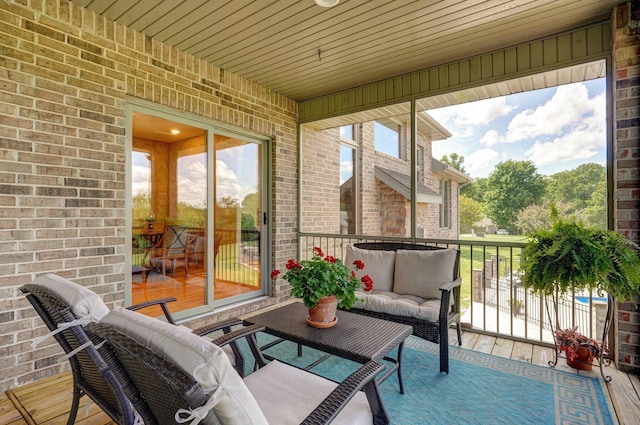 sunroom featuring outdoor lounge area and plenty of natural light
