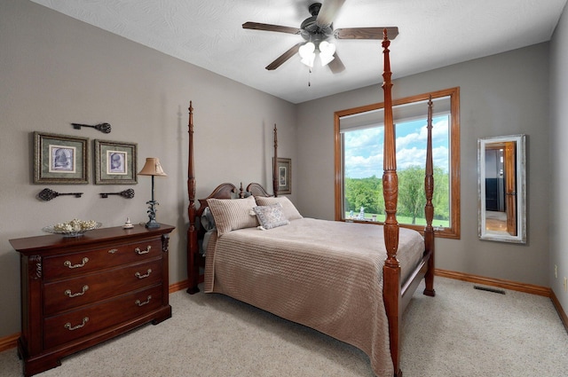 bedroom featuring baseboards, light carpet, and ceiling fan