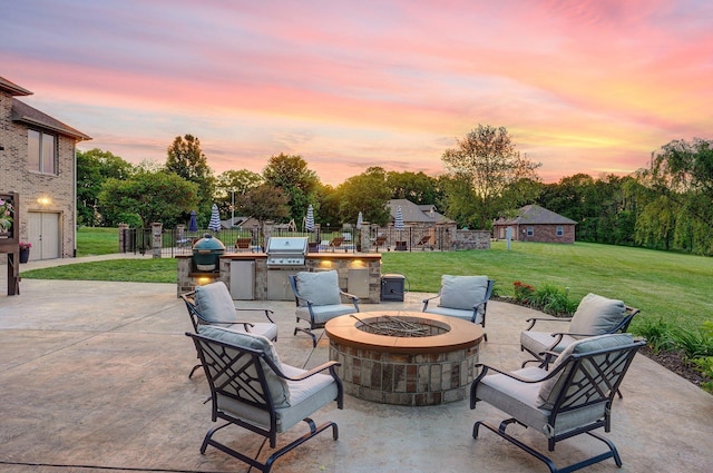 view of patio with an outdoor fire pit, an outdoor kitchen, and a grill