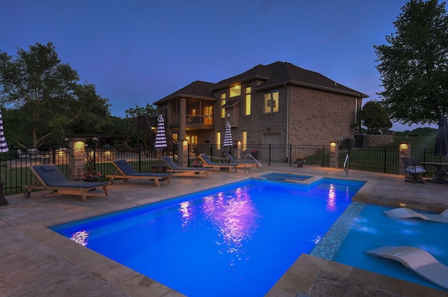 view of swimming pool with stairs, a patio area, a pool with connected hot tub, and fence