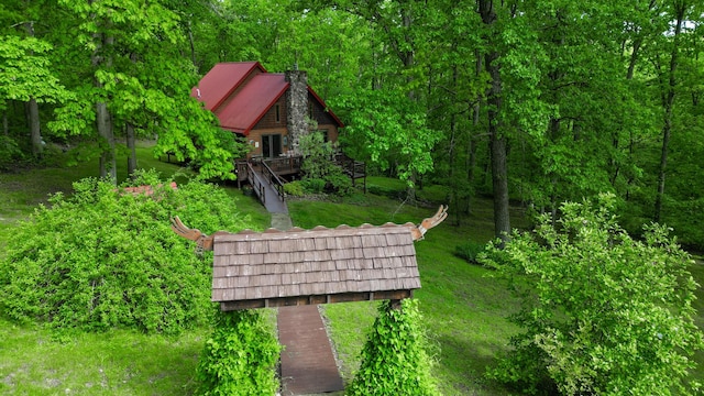 view from above of property featuring a heavily wooded area