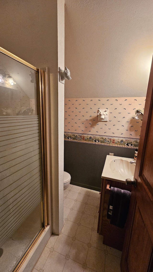 full bath with a shower stall, vanity, and toilet