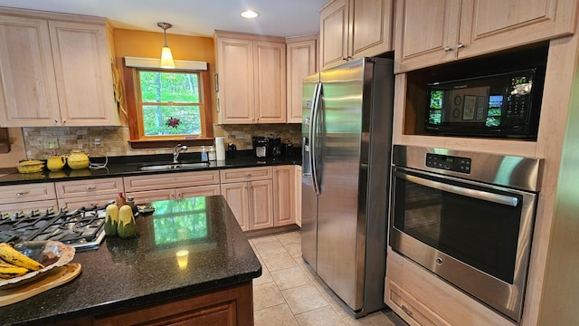 kitchen with appliances with stainless steel finishes, a sink, backsplash, light tile patterned flooring, and recessed lighting