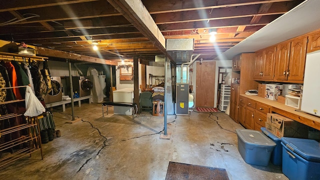 unfinished below grade area with separate washer and dryer and heating unit