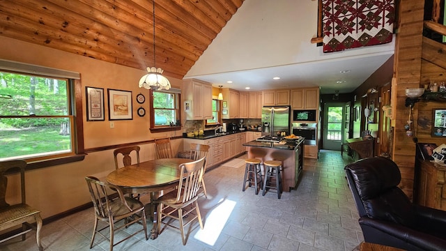 dining room with plenty of natural light, lofted ceiling, wood ceiling, and recessed lighting