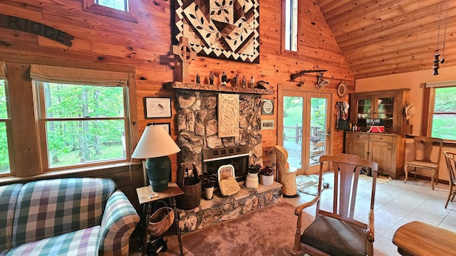 tiled living area featuring wood ceiling, wood walls, and high vaulted ceiling