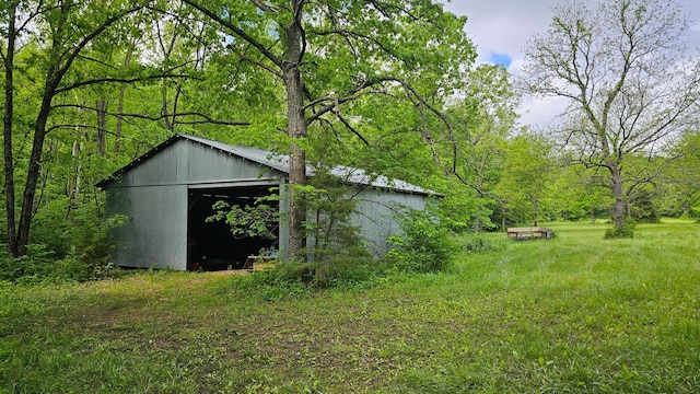 view of pole building with a wooded view